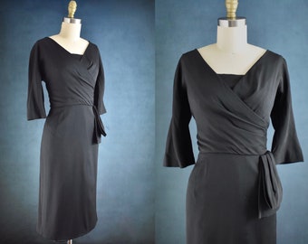 1950s-60s Vintage Black Cocktail Dinner Dress cross wrap bodice draped hip swag 3/4 length sleeves Abe Schrader designer label 29" waist