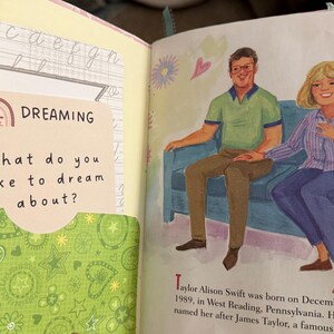 May include: A book with a green and white patterned cover. The book has a sticker on the front that says "DREAMING" and asks "What do you like to dream about?" The book also has a picture of a man and a woman sitting on a couch.