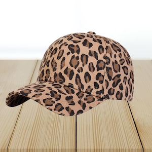 May include: A brown and black leopard print baseball cap.
