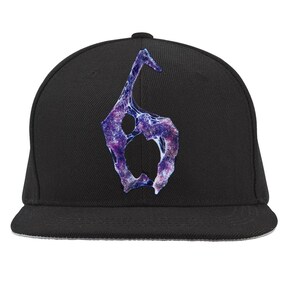 May include: Black flat-brimmed baseball cap featuring a purple and white abstract design. The design is a stylized number six. The cap has a structured crown and a flat brim, suitable for casual wear.