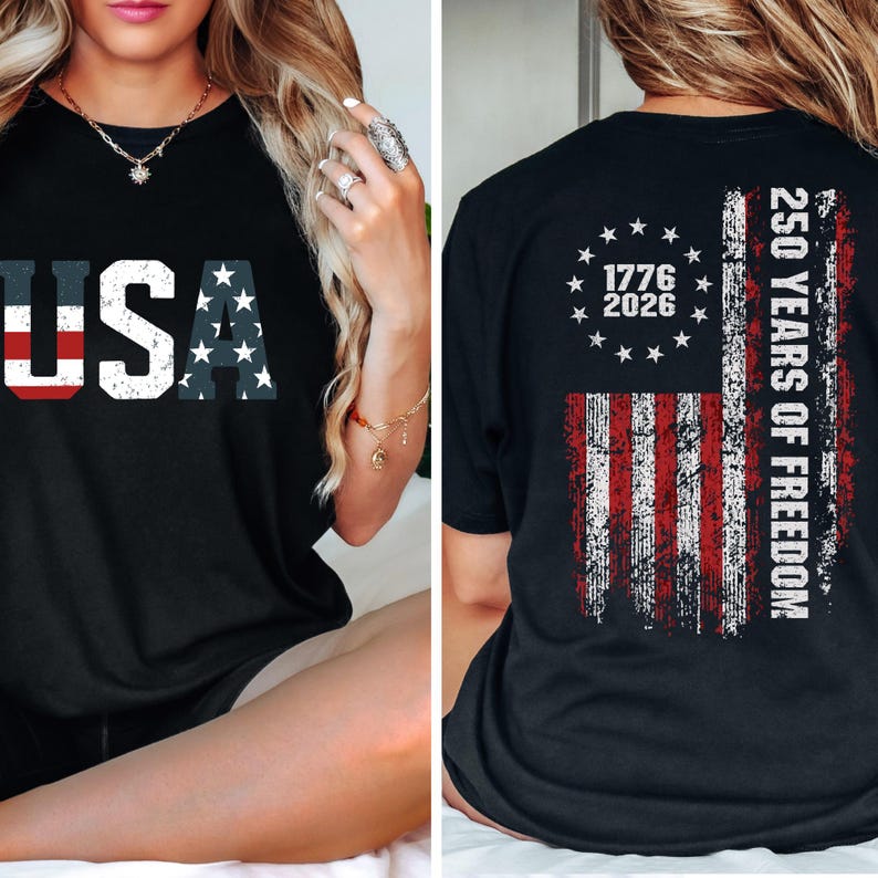 May include: A black t-shirt featuring a distressed USA graphic on the front. The back displays a distressed American flag design with a circle of stars, the years 1776 and 2026, and the text 250 YEARS OF FREEDOM in a bold, white, vertical font.