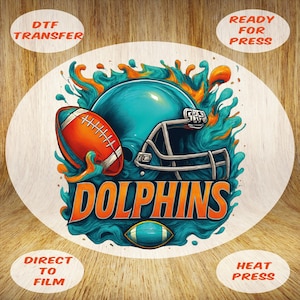 May include: A circular DTF transfer design featuring a football helmet and football in teal, orange, and white. The word "DOLPHINS" is in large orange letters. The design includes the text "DTF TRANSFER", "READY FOR PRESS", "DIRECT TO FILM", and "HEAT PRESS".