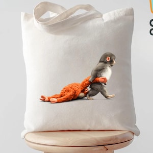 May include: A white tote bag with a whimsical illustration of a gray monkey carrying an orange stuffed animal. The bag has a simple design with a handle and the text "Custom ToteBags US".