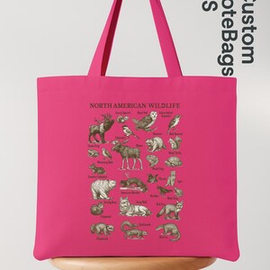 May include: A vibrant pink tote bag displaying an illustration of North American wildlife. The bag features various animals with their names, ideal for nature lovers. The bag has long handles.
