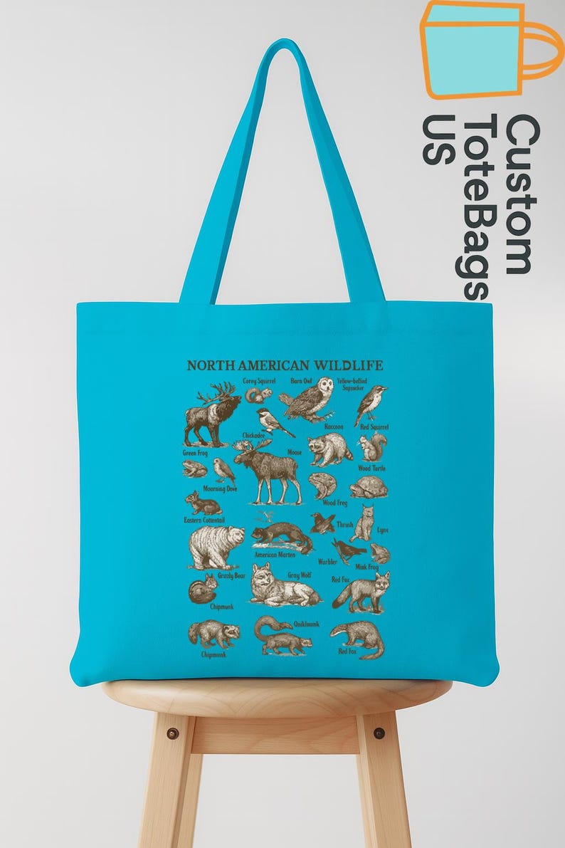 May include: A turquoise tote bag displaying an illustrated guide to North American wildlife. The design showcases animals like a moose, bear, owl, and fox, each labelled. The bag has a matching turquoise handle and the text "Custom Tote Bags US".
