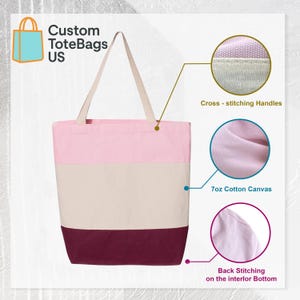 May include: A pink, cream, and burgundy tote bag with cream-colored handles. The bag is made of 7oz cotton canvas and features cross-stitching on the handles and back stitching on the interior bottom. The text "Custom ToteBags US" is in the upper left corner.
