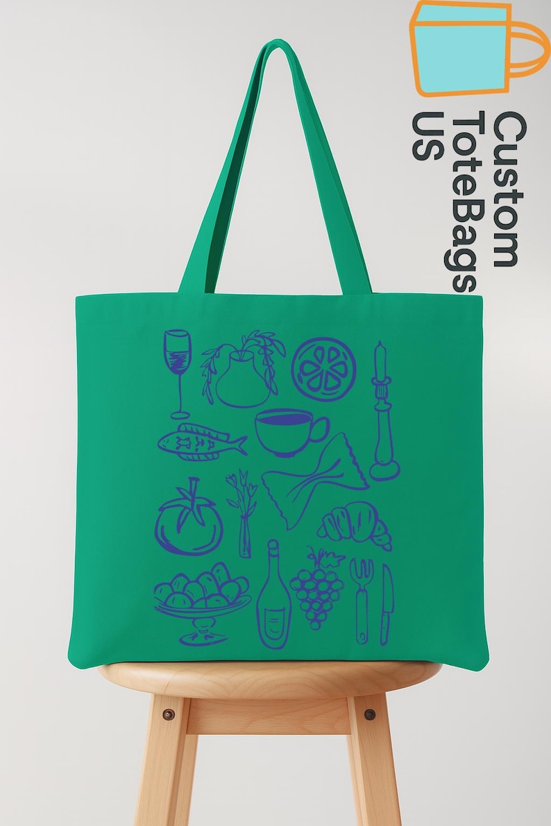 May include: A green tote bag with blue illustrations of food items like a wine glass, fish, and grapes. The bag has long handles and the text "Custom Tote Bags US" in a vertical orientation.