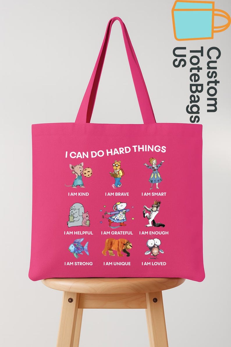 May include: A pink tote bag with the text "I CAN DO HARD THINGS" and illustrations of cartoon characters with positive affirmations. The bag also has the text "Custom ToteBags US".