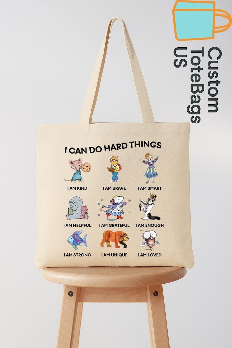 May include: Beige tote bag with the text "I CAN DO HARD THINGS" and illustrations of cartoon animals with positive affirmations like "I AM KIND" and "I AM BRAVE". The bag also has the text "Custom ToteBags US".