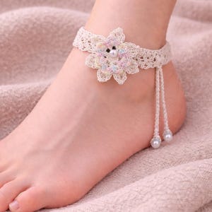 May include: A white ceramic mug with a black handle and the text "But First, Coffee" in a bold, black font. The mug is set against a blurred background, highlighting its clean design.