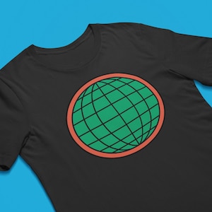 May include: A black short-sleeved t-shirt featuring a centered circular graphic. The design consists of a green globe with black grid lines, enclosed within a thick, solid coral-orange circular border. The shirt has a standard crew neckline.