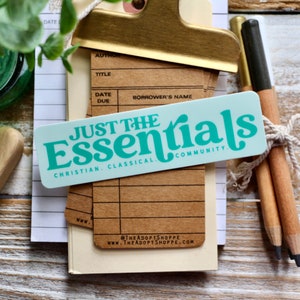 May include: A teal blue sticker with the text "Just the Essentials" in a retro font. The sticker also includes the text "Christian. Classical. Community."