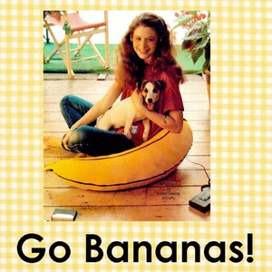 May include: A large, yellow, banana-shaped floor cushion with black stitched details. The text 'Go Bananas!' appears below the cushion. Three smaller images show a person interacting with a smaller, yellow, banana-shaped plush toy.