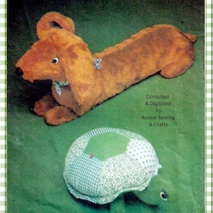 May include: A plush brown dachshund toy with long ears and a light blue collar, and a stuffed turtle toy with a green and white patchwork shell. The text reads: Compiled & Digitised by Aussie Sewing & Crafts. Both toys have visible eyes.