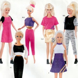 May include: Several Barbie dolls are displayed, each wearing different outfits. The outfits include a pink dress, a purple crop top with pink pants, a pink top with a gold skirt, a black and white top with black pants, and a purple dress.
