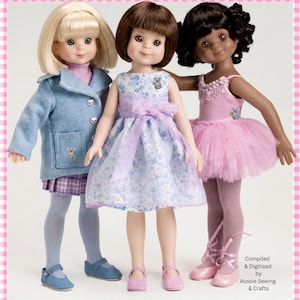 May include: Three dolls standing together. The left doll has blonde hair, a blue coat, and a plaid skirt. The center doll has brown hair and a blue floral dress with a lavender sash. The right doll has dark curly hair and a pink tutu dress.