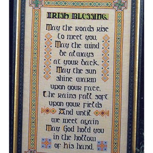 May include: A framed cross-stitch embroidery with an Irish blessing. The text reads: "May the roads rise to meet you, May the wind be always at your back. May the sun shine warm upon your face. The rains fall soft upon your fields And until we meet again May God hold you in the hollow of his hand."