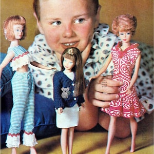 May include: Three dolls with distinct outfits. The left doll wears a blue and white gingham crop top and trousers with ruffled trim. The centre doll has long brown hair, a navy blue knit cardigan with a koala pin, and a white skirt. The right doll wears a pink and white patterned dress.