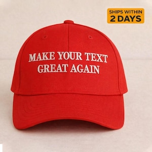 May include: A bright red baseball cap with a curved brim. The cap features white embroidered text that reads "MAKE YOUR TEXT GREAT AGAIN". The hat has a structured crown and a button on top.