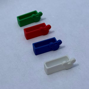 May include: Four silicone phone grips in different colours: green, red, blue, and white. Each grip has a Mickey Mouse ear design.