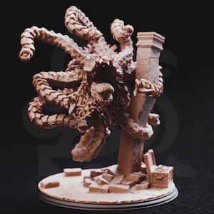 May include: A detailed, brown, fantasy creature sculpture with multiple tentacles and a large, open mouth. The creature is posed near a crumbling pillar and a treasure chest, suggesting a dungeon or fantasy setting. The sculpture is on a round base.