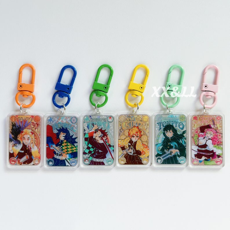 K&ouml;nnte beinhalten: Sechs Schl&uuml;sselanh&auml;nger aus Acryl mit Anime-Charakter-Illustrationen. Jeder Schl&uuml;sselanh&auml;nger hat einen unterschiedlich farbigen Karabinerhaken: orange, blau, gr&uuml;n, gelb, hellgr&uuml;n und rosa. Die rechteckigen Schl&uuml;sselanh&auml;nger haben detaillierte Designs.