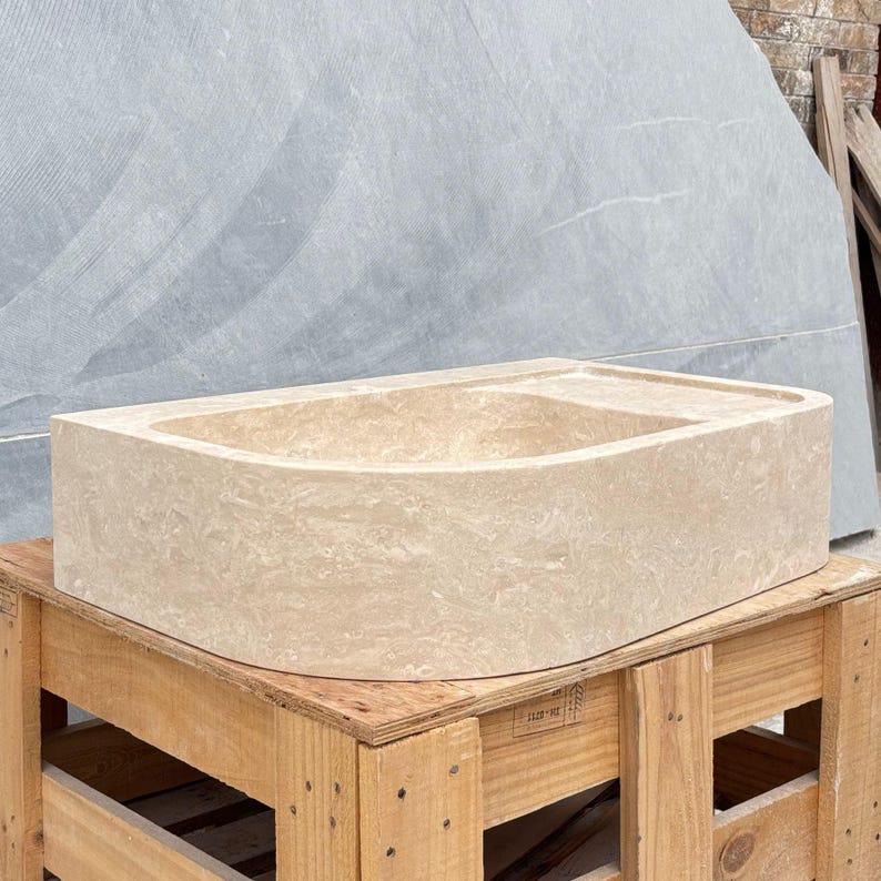 Solid travertine stone bathroom sink shown from front angle