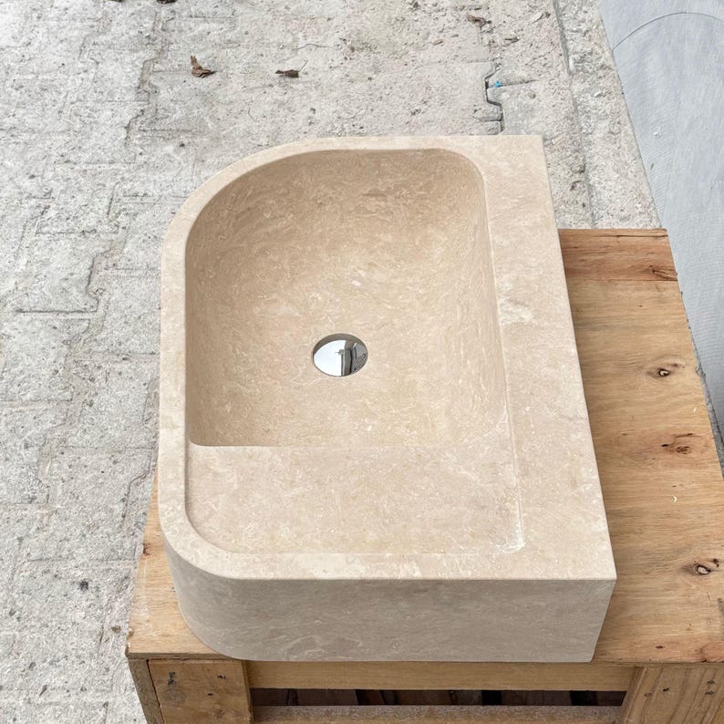 Top view of travertine marble sink with centered drain hole