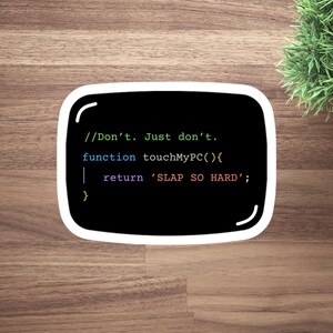 May include: A black sticker with a white border displaying computer code. The text reads "//Don't. Just don't. function touchMyPC(){ return 'SLAP SO HARD'; }". The sticker is on a wooden surface with a small green plant in the background.