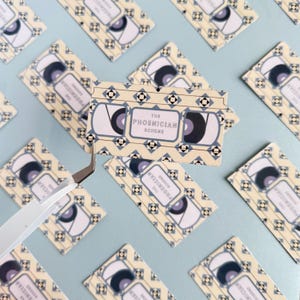 Nostalgic VHS Wes Anderson Sticker | 3” VHS Phoenician Scheme Sticker  | Glossy Waterproof Pop Culture Sticker Gift for Movie Lovers