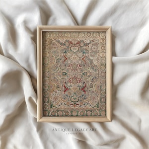 May include: A framed print featuring a detailed, antique rug design. The rug has a complex pattern with red, green, and beige hues. The frame is light-colored wood. The text "ANTIQUE LEGACY ART Curated Art" is at the bottom.