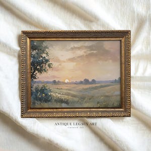 May include: A framed landscape painting with a gold ornate frame. The artwork depicts a sunset over a field with a tree on the left side. The text "ANTIQUE LEGACY ART" and "Curated Art" is visible at the bottom.