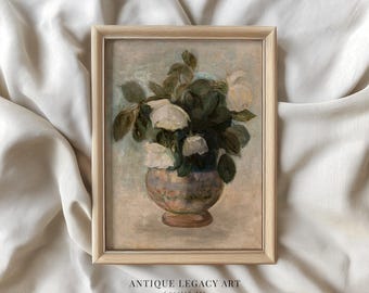 May include: A framed vintage floral painting featuring white roses in a decorative vase. The artwork has a soft color palette with green leaves and a light brown wooden frame. The text "ANTIQUE LEGACY ART Curated Art" is at the bottom.