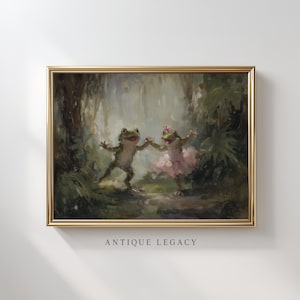 May include: A framed painting featuring two dancing frogs in a forest setting. One frog wears a pink tutu and a flower, while the other frog is without accessories. The painting has a gold frame and the text "ANTIQUE LEGACY" at the bottom.