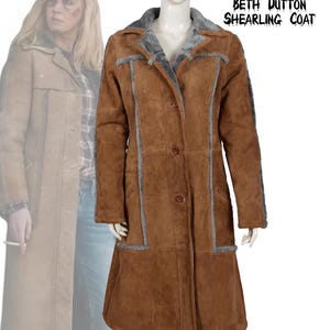 May include: A brown shearling coat with gray trim and a gray shearling collar. The coat has three buttons and is displayed on a mannequin. The text "Yellowstone Beth Dutton Shearling Coat" is visible.