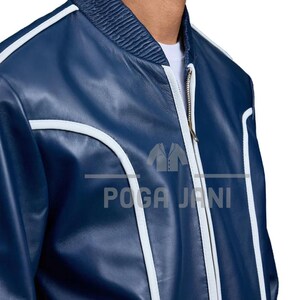 May include: A navy blue bomber jacket with white trim and a ribbed collar. The jacket features a zipper closure and the text "POGA JANI" in white. A stylish outerwear piece.