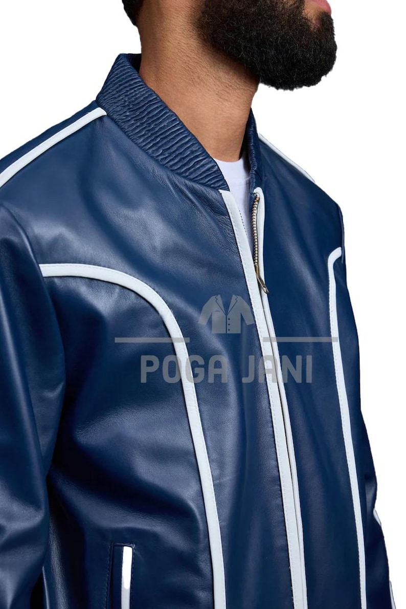 May include: A navy blue bomber jacket with white trim and a ribbed collar. The jacket features a zipper closure and the text "POGA JANI" in white. A stylish outerwear piece.