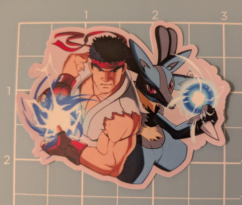 May include: A sticker featuring two characters: a muscular man in a white gi with a red headband and a blue and black creature. The man is throwing a blue energy blast, and the creature is holding a blue energy ball.