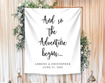 May include: White wedding backdrop with the text "And so the adventure begins..." with the names "Lorene & Cristopher" and the date "June 21, 2022" printed below.