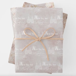 Happily Ever After soft blush wrapping paper sheets featuring a fairytale castle and elegant script text for a wedding or bridal shower.