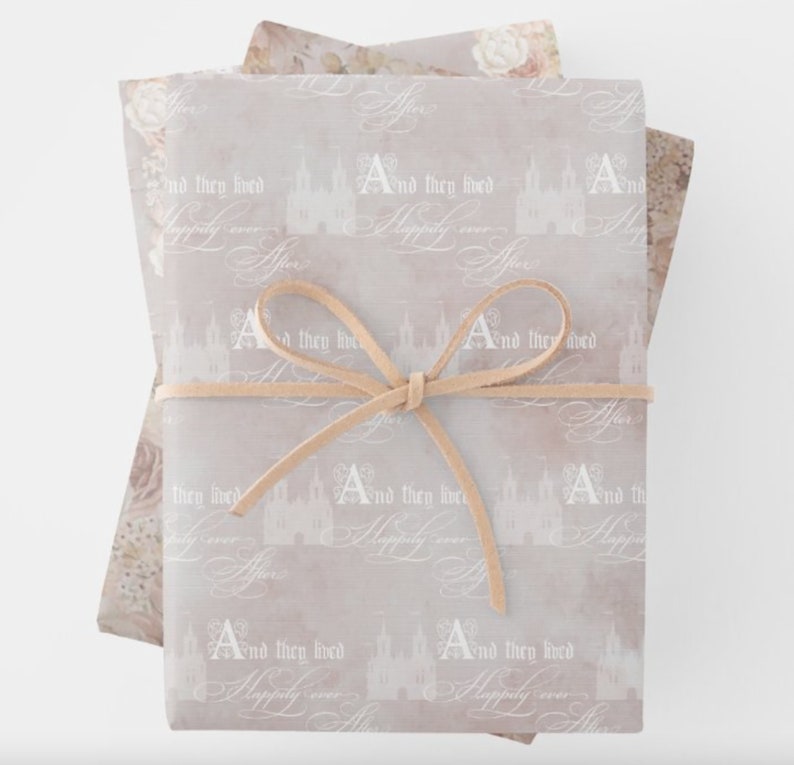 Happily Ever After soft blush wrapping paper sheets featuring a fairytale castle and elegant script text for a wedding or bridal shower.