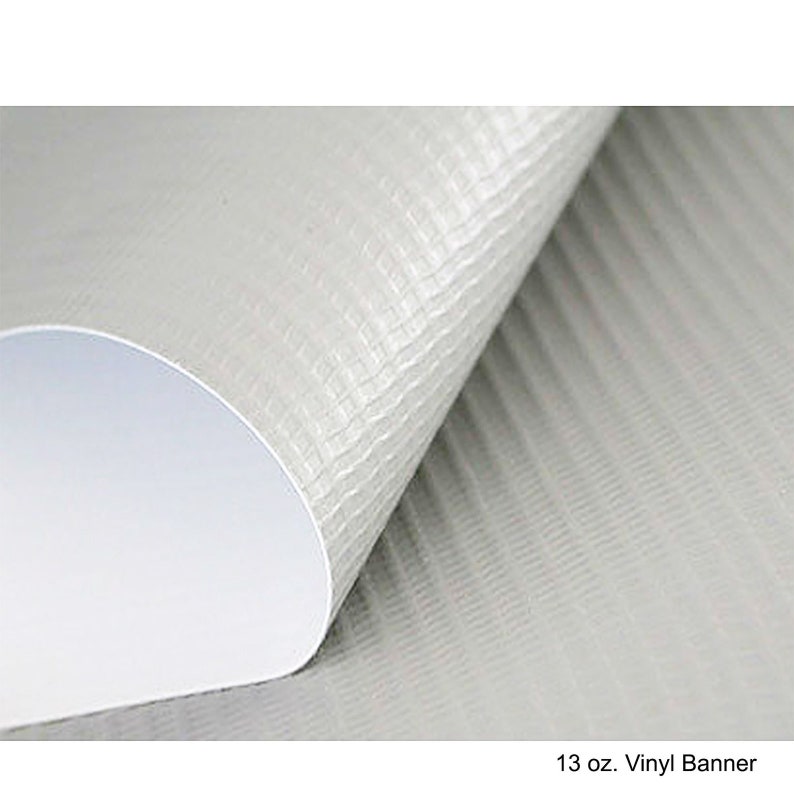 May include: A rolled-up, off-white vinyl banner with a textured surface. The banner has a white interior and the text "13 oz. Vinyl Banner" at the bottom.