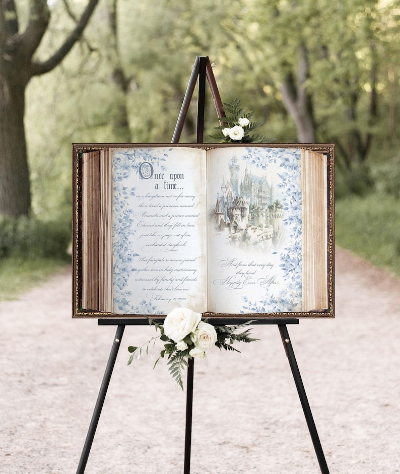 Our storybook welcome sign features blue flowers bordering the pages of our vintage book background with your custom event details in a beautiful script font. A blue fairytale castle adorns the opposite page.