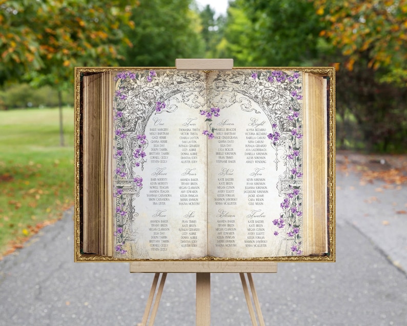 This unique seating chart sign looks like an open book and features a vintage floral border and purple flowers on a gold framed background. We customize your seating chart in a pretty dark gray font.