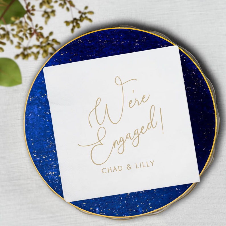 Elegant and simple We're Engaged napkins customized with your names.