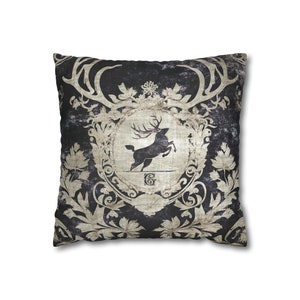 May include: A black and white throw pillow with a vintage design featuring a stag with antlers and a floral pattern.