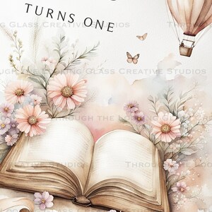 Close-up of custom book backdrop featuring pale pastel wildflowers, open book, and personalized text "A New Chapter Begins" for first birthday.