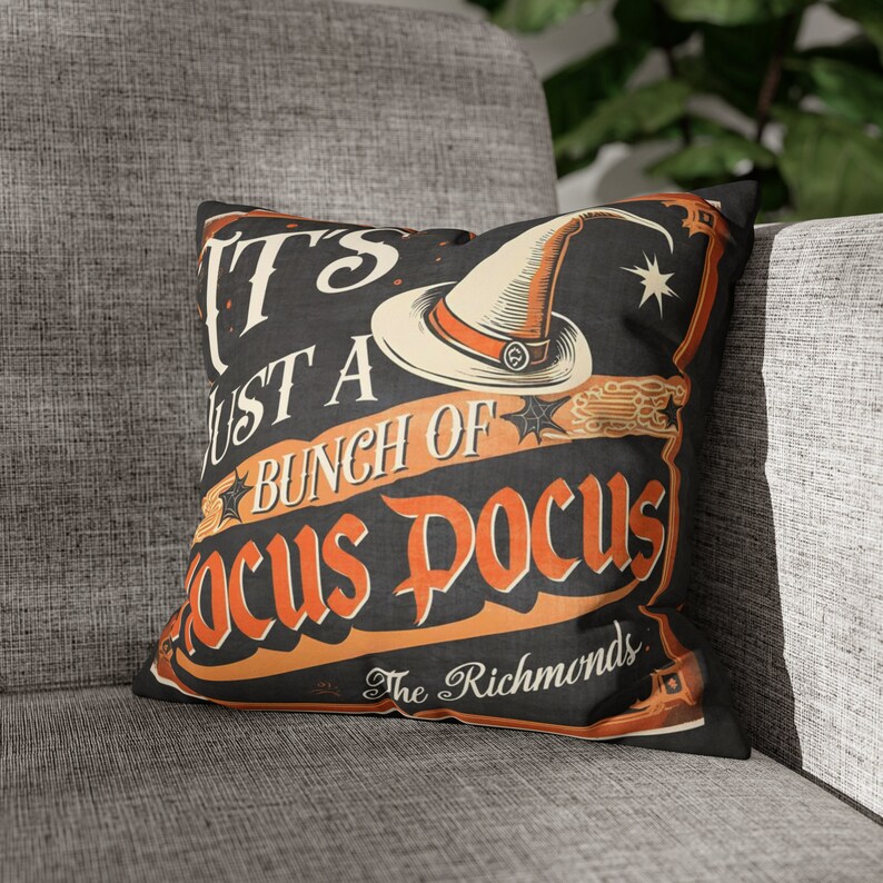 May include: A black and orange Halloween themed throw pillow with a witch's hat and the text "It's Just A Bunch Of Focus Pocus The Richmonds".