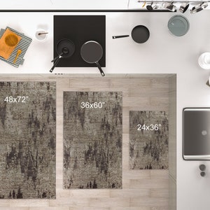 May include: Three kitchen rugs in different sizes, 48x72 inches, 36x60 inches, and 24x36 inches. The rugs are a light grey with dark grey abstract patterns.
