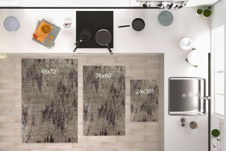 May include: Three kitchen rugs in different sizes, 48x72 inches, 36x60 inches, and 24x36 inches. The rugs are a light grey with dark grey abstract patterns.